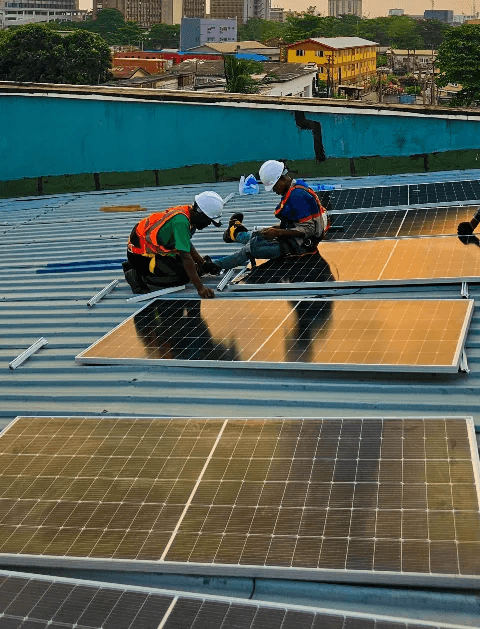 Technicians installing solar panels on a rooftop in Lagos